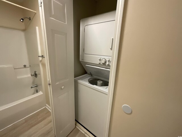 1900 Duffy St Unit L-5, North Myrtle Beach, SC 29582 - laundry area featuring stacked washer / drying machine and light wood-style flooring