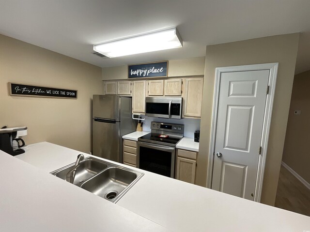 1900 Duffy St Unit L-5, North Myrtle Beach, SC 29582 - kitchen with appliances with stainless steel finishes, light countertops, a sink, and wood finished floors