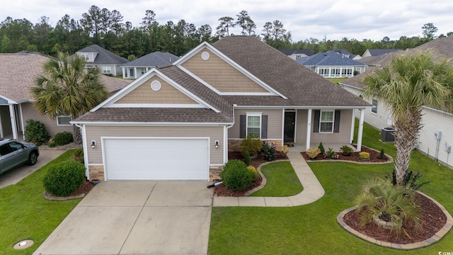 1224 Checkerberry St, Longs, SC 29568 - view of front facade with driveway, stone siding, roof with shingles, an attached garage, and a front lawn