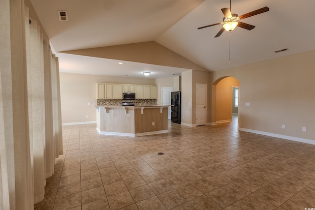 1224 Checkerberry St, Longs, SC 29568 - kitchen with freestanding refrigerator, stainless steel microwave, open floor plan, backsplash, and a kitchen breakfast bar