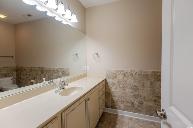 1224 Checkerberry St, Longs, SC 29568 - bathroom featuring toilet, vanity, tile patterned floors, wainscoting, and tile walls