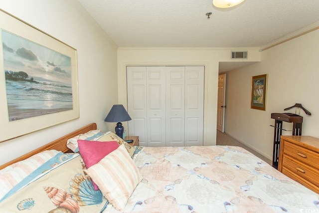 305 N Hillside Dr Unit 206, North Myrtle Beach, SC 29582 - carpeted bedroom with a closet, ornamental molding, and a textured ceiling