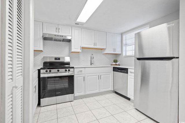 6703 Jefferson Pl Unit B7, Myrtle Beach, SC 29572 - kitchen featuring stainless steel appliances, under cabinet range hood, light countertops, white cabinets, and light tile patterned floors