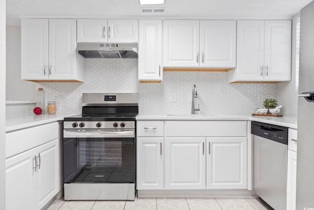 6703 Jefferson Pl Unit B7, Myrtle Beach, SC 29572 - kitchen featuring appliances with stainless steel finishes, under cabinet range hood, light countertops, white cabinets, and decorative backsplash