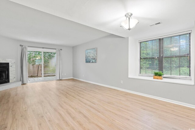 6703 Jefferson Pl Unit B7, Myrtle Beach, SC 29572 - unfurnished living room featuring wood finished floors and a fireplace