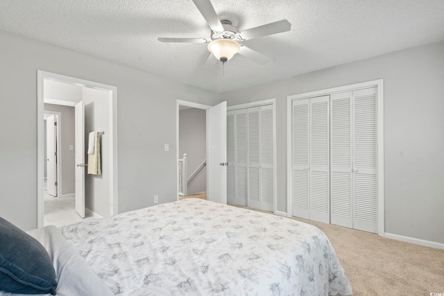 6703 Jefferson Pl Unit B7, Myrtle Beach, SC 29572 - carpeted bedroom with two closets, a textured ceiling, and ceiling fan