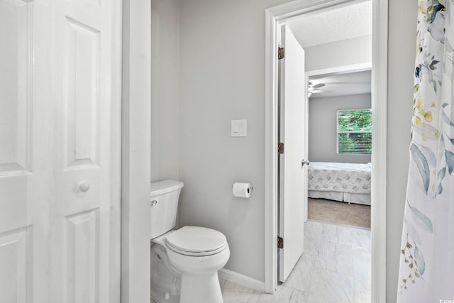 6703 Jefferson Pl Unit B7, Myrtle Beach, SC 29572 - ensuite bathroom with marble look tile flooring, a textured ceiling, and a ceiling fan