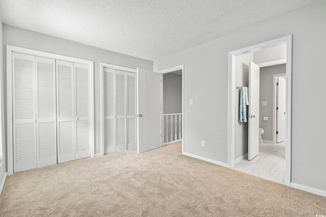 6703 Jefferson Pl Unit B7, Myrtle Beach, SC 29572 - unfurnished bedroom with two closets, carpet flooring, and a textured ceiling