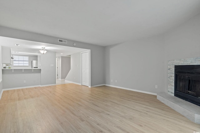 6703 Jefferson Pl Unit B7, Myrtle Beach, SC 29572 - unfurnished living room with light wood-type flooring and a fireplace