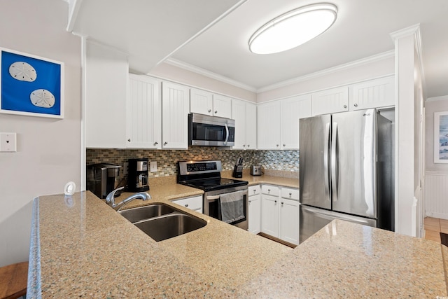 208 Ocean Blvd N Unit 226, North Myrtle Beach, SC 29582 - kitchen with stainless steel appliances, light stone counters, backsplash, white cabinetry, and crown molding