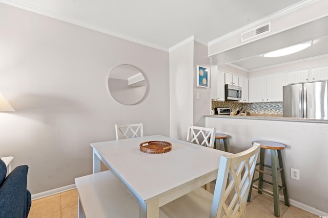 208 Ocean Blvd N Unit 226, North Myrtle Beach, SC 29582 - dining area featuring crown molding and light tile patterned floors