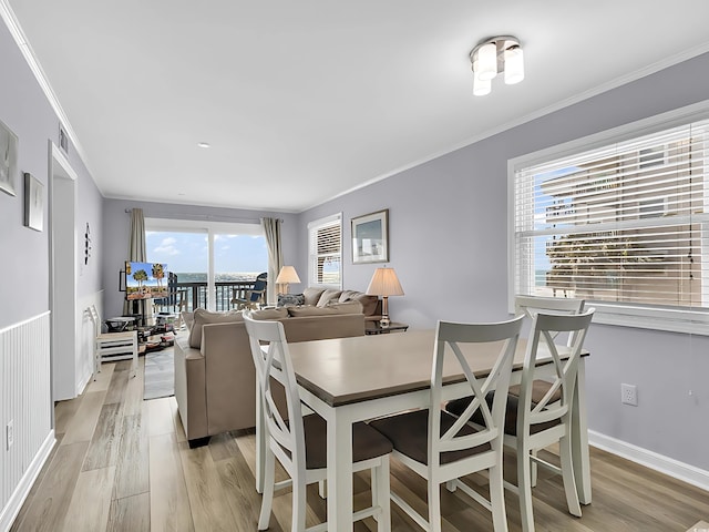 1310 N Waccamaw Dr Unit 208, Garden City Beach, SC 29576 - dining space featuring light wood finished floors, ornamental molding, and baseboards