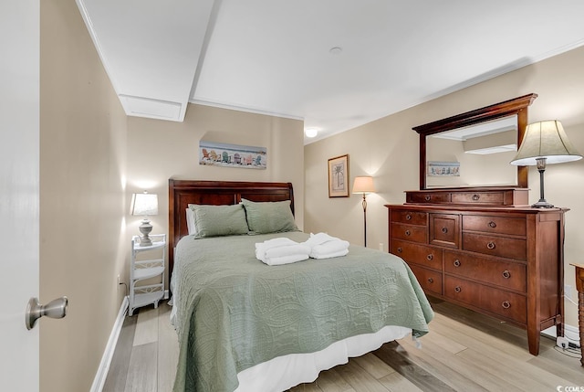 1310 N Waccamaw Dr Unit 208, Garden City Beach, SC 29576 - bedroom featuring light wood finished floors, ornamental molding, and baseboards