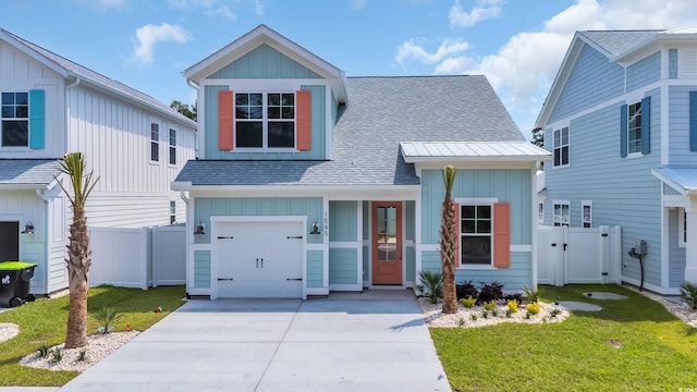 1545 Coastal Cove Ln, Calabash, NC 28467 - view of front of house with board and batten siding, roof with shingles, a gate, a garage, and driveway