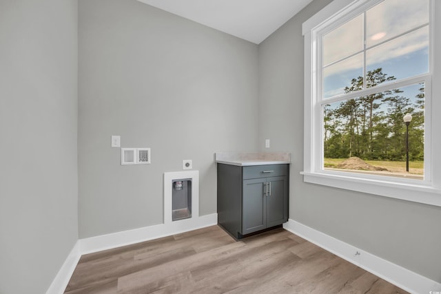 1545 Coastal Cove Ln, Calabash, NC 28467 - laundry area featuring hookup for an electric dryer, light wood-type flooring, baseboards, and cabinet space