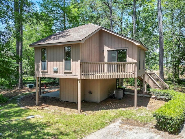 752 Tall Oaks Ct, Myrtle Beach, SC 29588 - view of home's exterior featuring central AC, stairs, roof with shingles, and a wooden deck