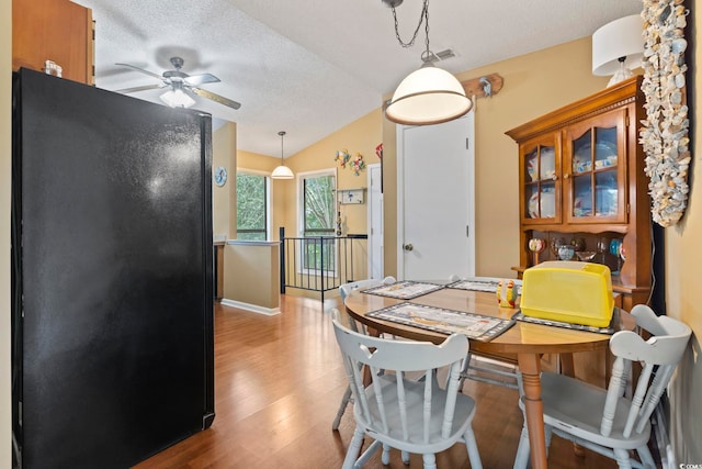 752 Tall Oaks Ct, Myrtle Beach, SC 29588 - dining room with wood finished floors, vaulted ceiling, ceiling fan, a textured ceiling, and baseboards