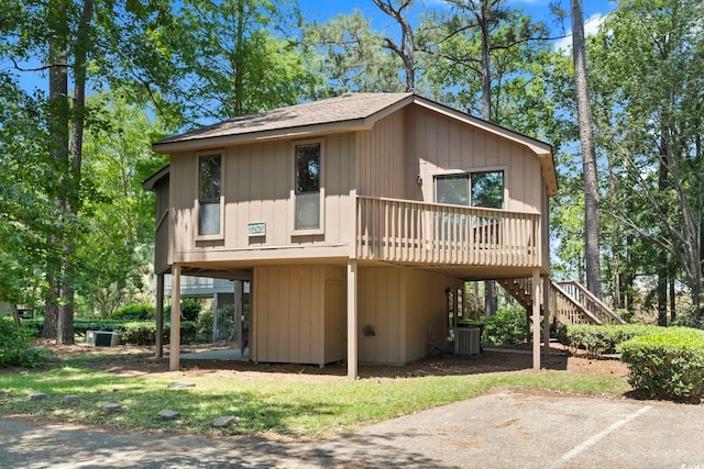 752 Tall Oaks Ct, Myrtle Beach, SC 29588 - view of front of house featuring stairway, cooling unit, and roof with shingles