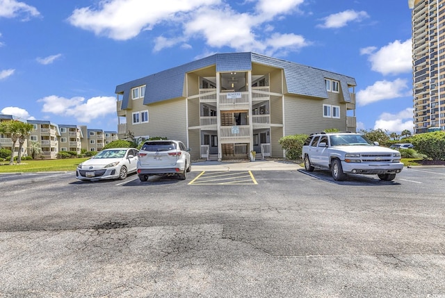 9660 Shore Dr Unit 208, Myrtle Beach, SC 29572 - view of building exterior with uncovered parking