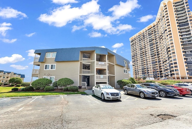 9660 Shore Dr Unit 208, Myrtle Beach, SC 29572 - view of apartment building / complex featuring uncovered parking