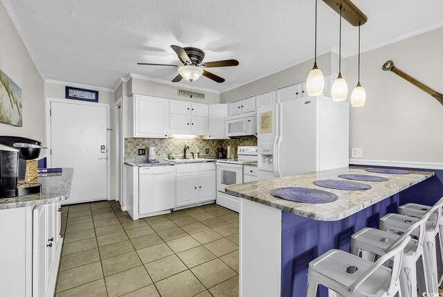 9660 Shore Dr Unit 208, Myrtle Beach, SC 29572 - kitchen featuring white appliances, a ceiling fan, a peninsula, white cabinets, and a sink