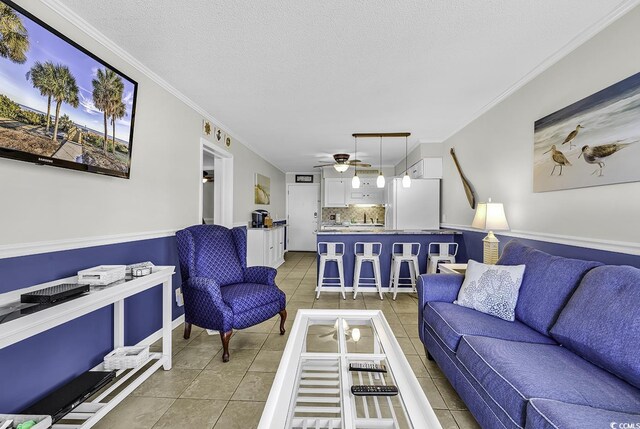 9660 Shore Dr Unit 208, Myrtle Beach, SC 29572 - living area with light tile patterned floors, ceiling fan, ornamental molding, and a textured ceiling