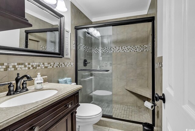 9660 Shore Dr Unit 208, Myrtle Beach, SC 29572 - bathroom featuring toilet, a shower stall, vanity, tile walls, and ornamental molding