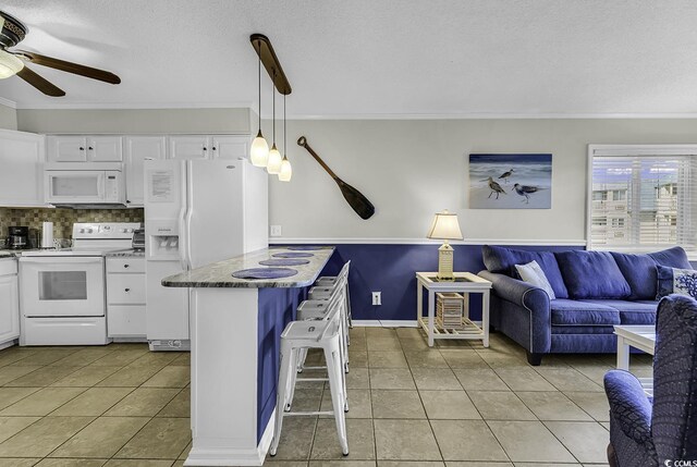 9660 Shore Dr Unit 208, Myrtle Beach, SC 29572 - kitchen featuring white appliances, ornamental molding, light tile patterned floors, white cabinetry, and a ceiling fan