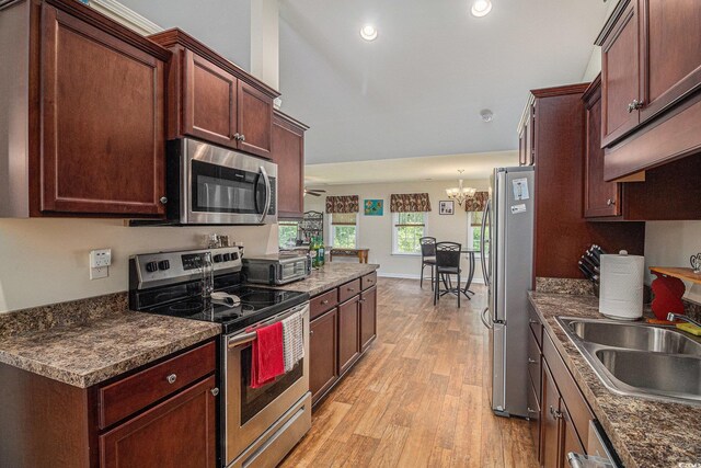 95 Timber Run Dr, Georgetown, SC 29440 - kitchen featuring appliances with stainless steel finishes, a chandelier, dark countertops, light wood-style floors, and recessed lighting
