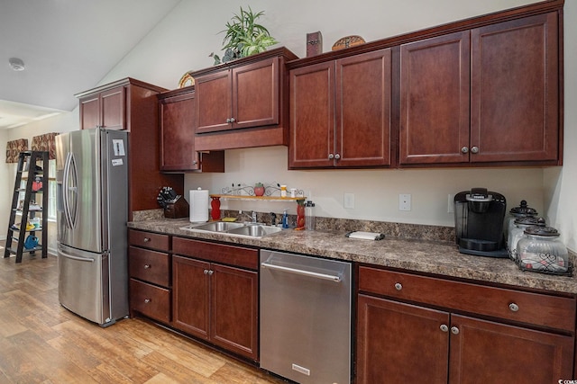95 Timber Run Dr, Georgetown, SC 29440 - kitchen featuring stainless steel appliances, light wood-style floors, dark countertops, and lofted ceiling
