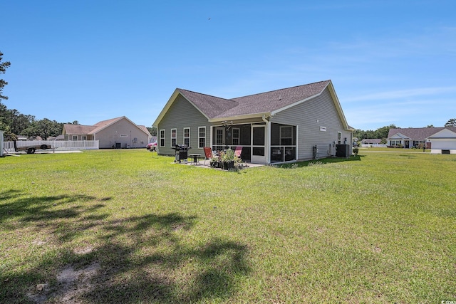 95 Timber Run Dr, Georgetown, SC 29440 - back of house featuring a lawn, a sunroom, a ceiling fan, and a shingled roof