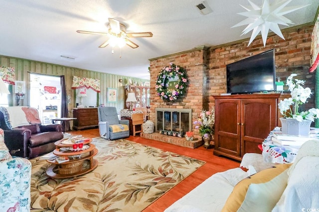 404 13th Ave S, Myrtle Beach, SC 29577 - living area featuring ceiling fan, a fireplace, wood finished floors, and brick wall