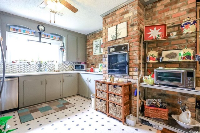 404 13th Ave S, Myrtle Beach, SC 29577 - kitchen with appliances with stainless steel finishes, gray cabinetry, light floors, ceiling fan, and a textured ceiling