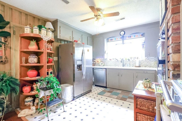 404 13th Ave S, Myrtle Beach, SC 29577 - kitchen with appliances with stainless steel finishes, gray cabinets, ceiling fan, light floors, and a textured ceiling