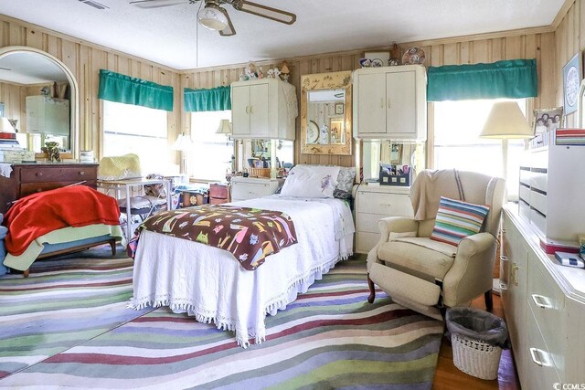 404 13th Ave S, Myrtle Beach, SC 29577 - bedroom with multiple windows, wooden walls, and ceiling fan