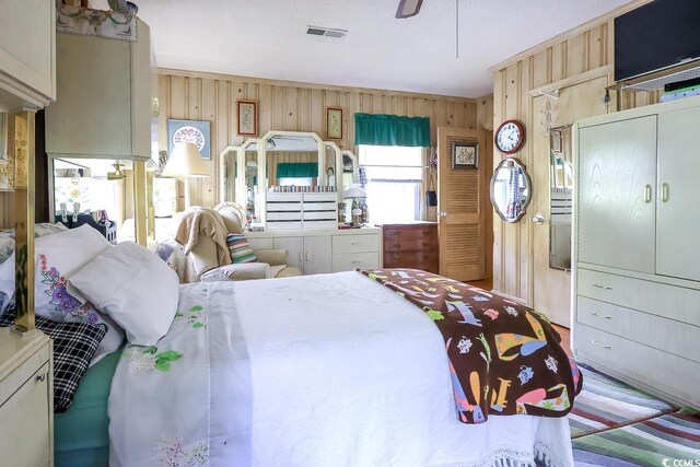 404 13th Ave S, Myrtle Beach, SC 29577 - bedroom featuring wooden walls and ceiling fan