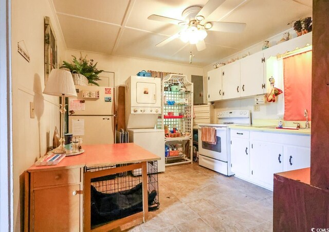 404 13th Ave S, Myrtle Beach, SC 29577 - kitchen with electric stove, stacked washing machine and dryer, a ceiling fan, light countertops, and white cabinets