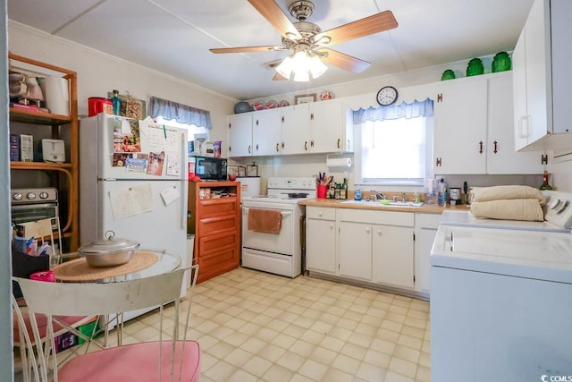 404 13th Ave S, Myrtle Beach, SC 29577 - kitchen with white appliances, washer / dryer, a sink, a ceiling fan, and light countertops