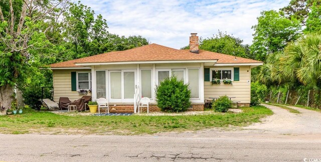 404 13th Ave S, Myrtle Beach, SC 29577 - bungalow-style home featuring entry steps, a chimney, and roof with shingles