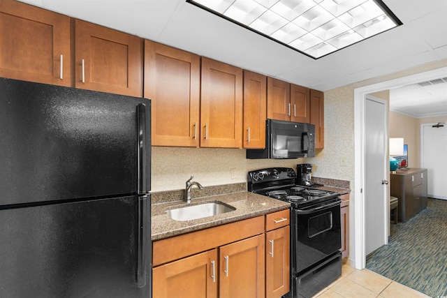 1105 S Ocean Blvd Unit 110, Myrtle Beach, SC 29577 - kitchen featuring black appliances, a sink, dark stone countertops, brown cabinets, and light tile patterned floors