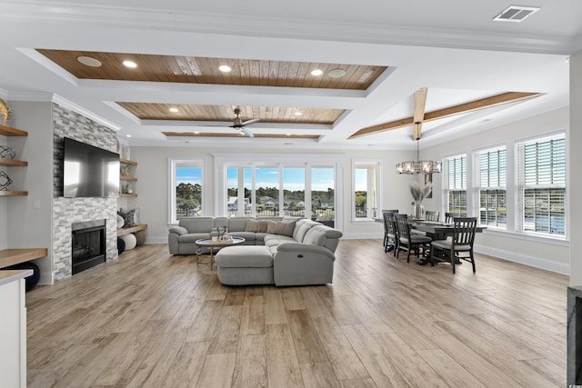 208 W Palms Dr, Myrtle Beach, SC 29579 - living room with plenty of natural light, light wood-style flooring, a stone fireplace, wood ceiling with exposed beams, and a chandelier