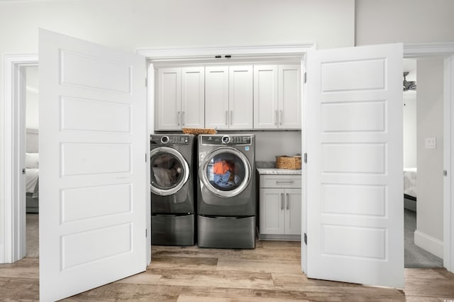 208 W Palms Dr, Myrtle Beach, SC 29579 - laundry room with cabinet space, washing machine and dryer, and light wood-type flooring