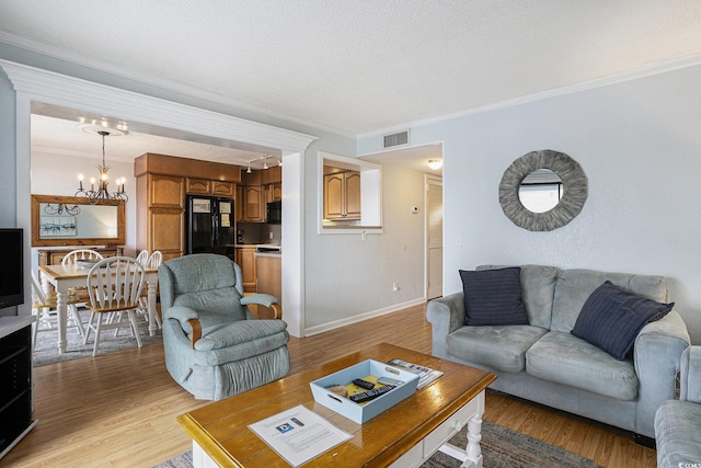 5905 S Kings Hwy Unit A518, Myrtle Beach, SC 29575 - living area featuring a chandelier, light wood-type flooring, ornamental molding, and baseboards