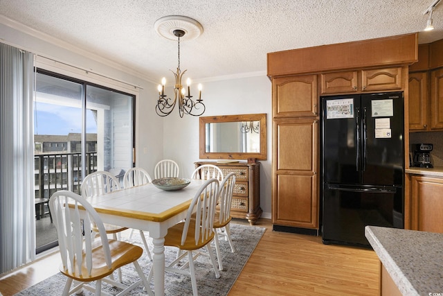5905 S Kings Hwy Unit A518, Myrtle Beach, SC 29575 - dining area featuring ornamental molding, a chandelier, light wood-style floors, and a textured ceiling