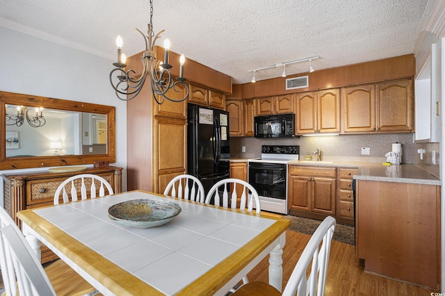 5905 S Kings Hwy Unit A518, Myrtle Beach, SC 29575 - dining space with a chandelier, wood finished floors, a textured ceiling, ornamental molding, and track lighting
