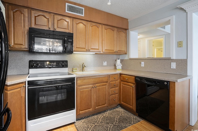 5905 S Kings Hwy Unit A518, Myrtle Beach, SC 29575 - kitchen featuring black appliances, a sink, decorative backsplash, light countertops, and a textured ceiling