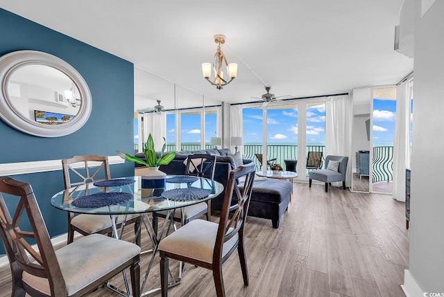2500 N Ocean Blvd Unit 1102, Myrtle Beach, SC 29577 - dining area featuring ceiling fan, wood finished floors, expansive windows, and a chandelier