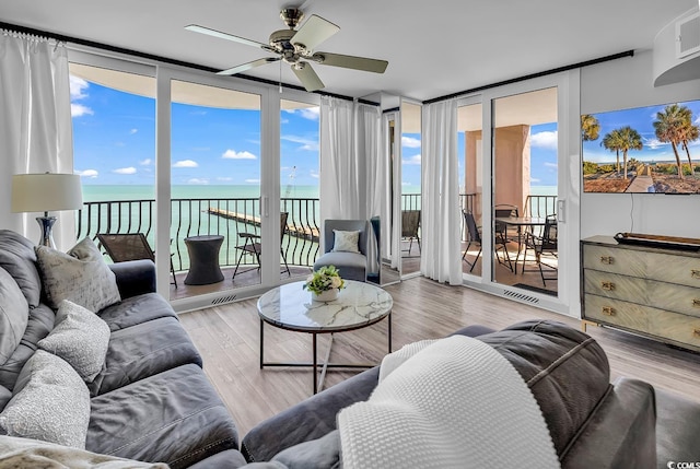 2500 N Ocean Blvd Unit 1102, Myrtle Beach, SC 29577 - living area with a ceiling fan, a water view, and wood finished floors