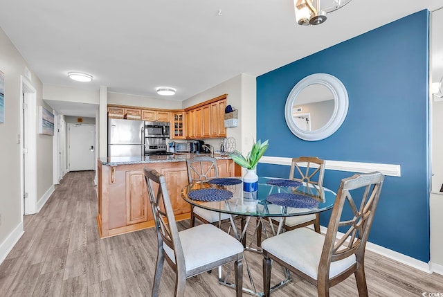 2500 N Ocean Blvd Unit 1102, Myrtle Beach, SC 29577 - dining space featuring baseboards and light wood-style flooring