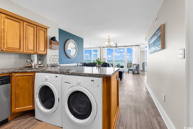 2500 N Ocean Blvd Unit 1102, Myrtle Beach, SC 29577 - laundry area featuring separate washer and dryer, light wood-style flooring, and a chandelier